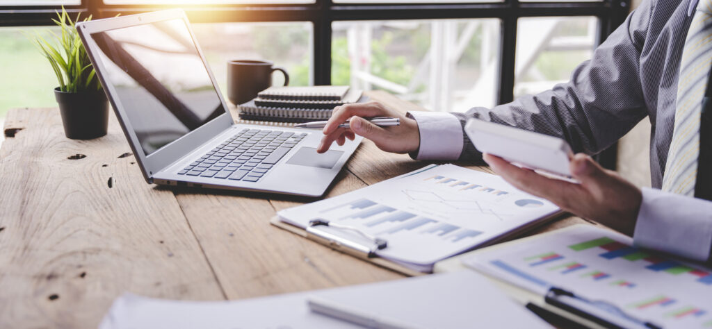 A working on a laptop doing tax services.