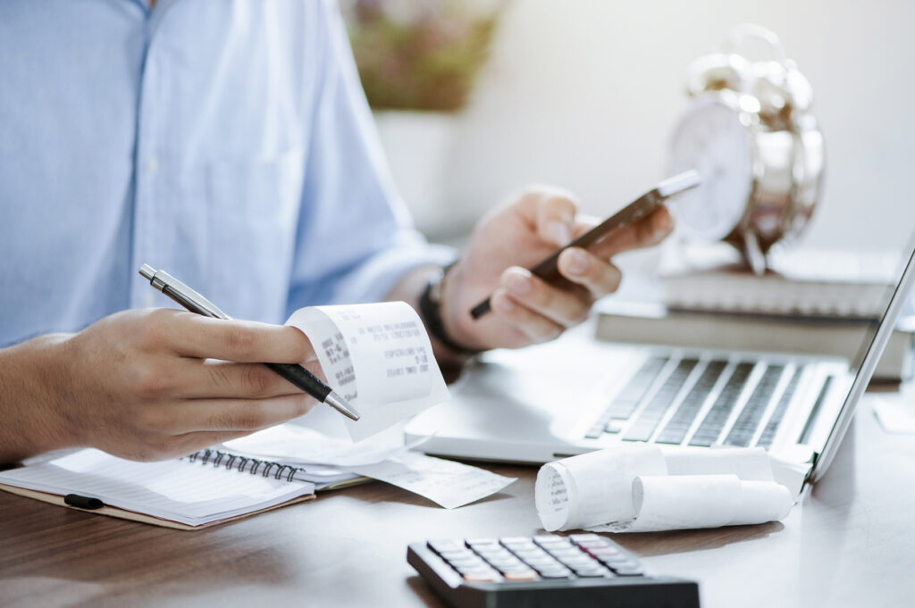 A man holding pen doing tax accounting services.