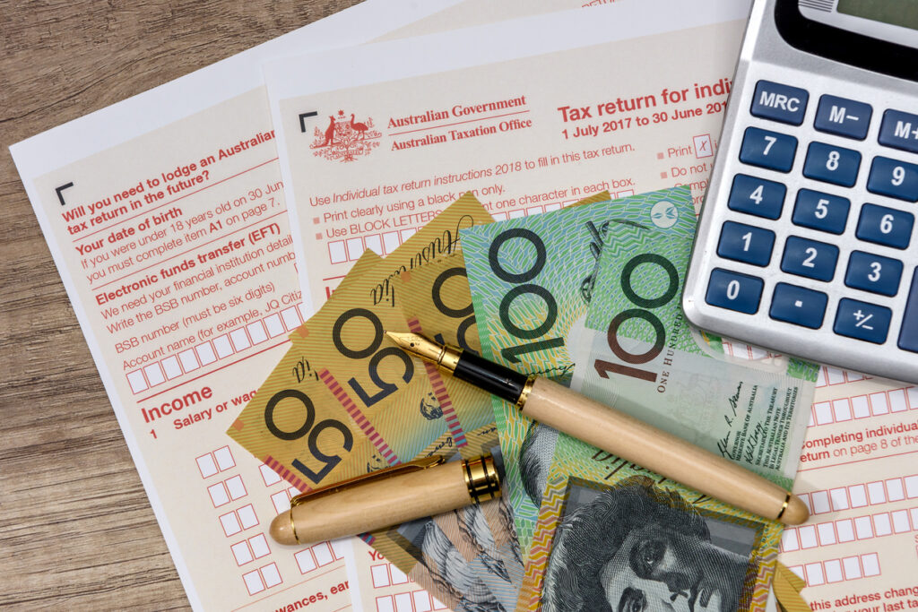Australian dollars with calculator and tax form.